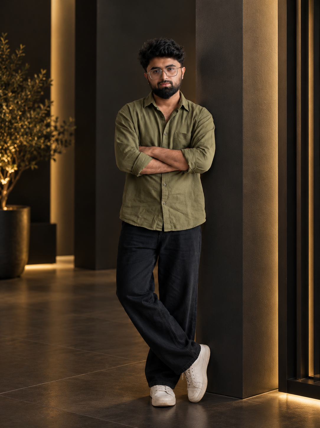 Mohammad Shahzeb Iqbal standing in olive shirt in a modern architectural interior